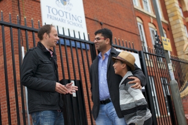 Dan with local parent and son outside the Tooting Primary School